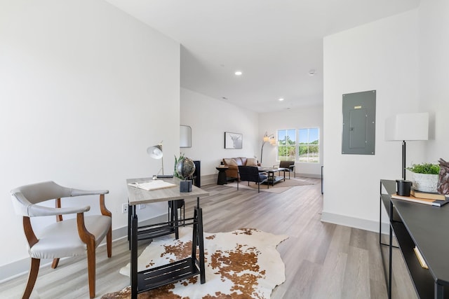 office with electric panel, recessed lighting, light wood-style floors, and baseboards