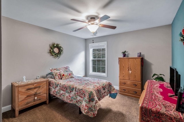 bedroom featuring ceiling fan, baseboards, and carpet