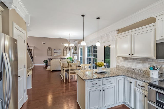 kitchen with a peninsula, open floor plan, backsplash, dark wood-type flooring, and appliances with stainless steel finishes