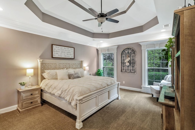 bedroom with a raised ceiling, carpet flooring, baseboards, and visible vents