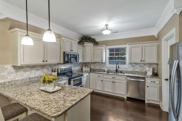 kitchen featuring a sink, appliances with stainless steel finishes, a peninsula, dark wood-type flooring, and light stone counters