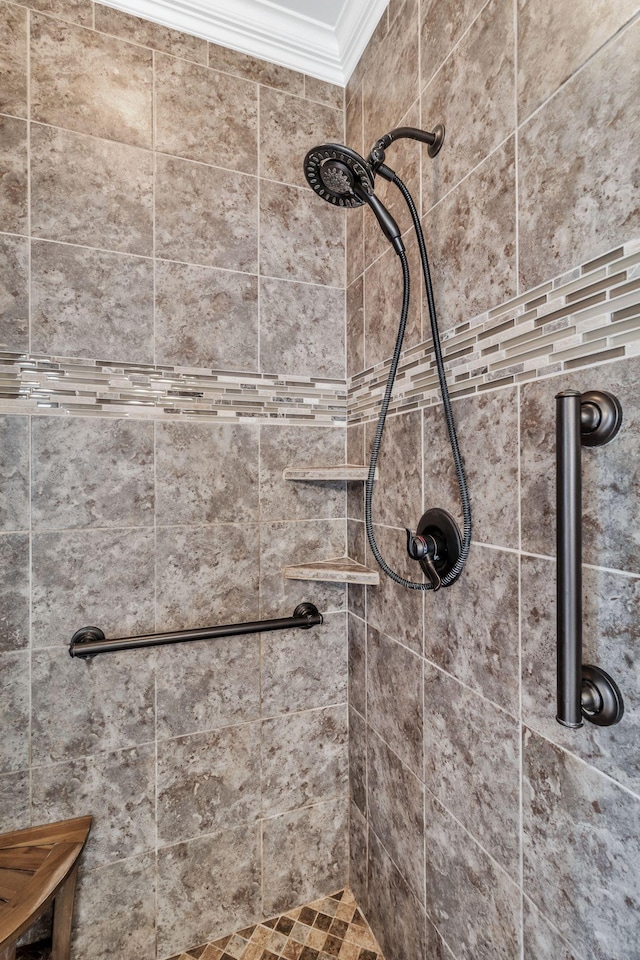 full bathroom with crown molding and tiled shower