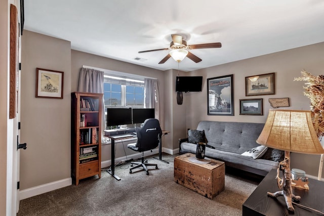 carpeted home office with baseboards, a ceiling fan, and visible vents