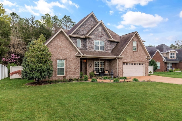 view of front of home featuring a garage, fence, brick siding, a front lawn, and driveway