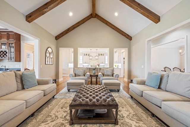 620 Williamson County Line Rd, Fairview, TN 37062 - living room with beamed ceiling, light wood-style flooring, high vaulted ceiling, and an inviting chandelier