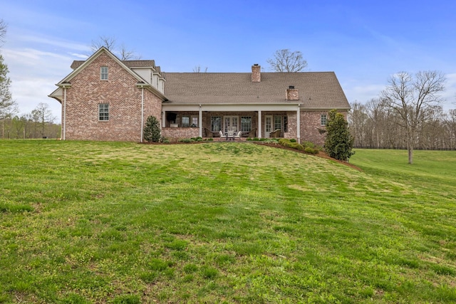 620 Williamson County Line Rd, Fairview, TN 37062 - back of property with brick siding, a lawn, and a chimney