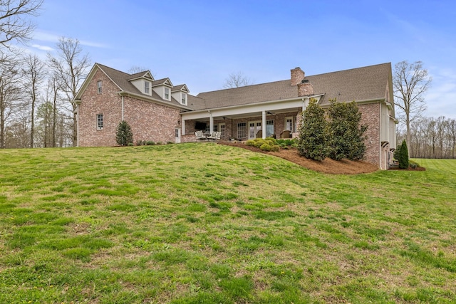 620 Williamson County Line Rd, Fairview, TN 37062 - view of front of home featuring a chimney, a ceiling fan, a front lawn, and brick siding
