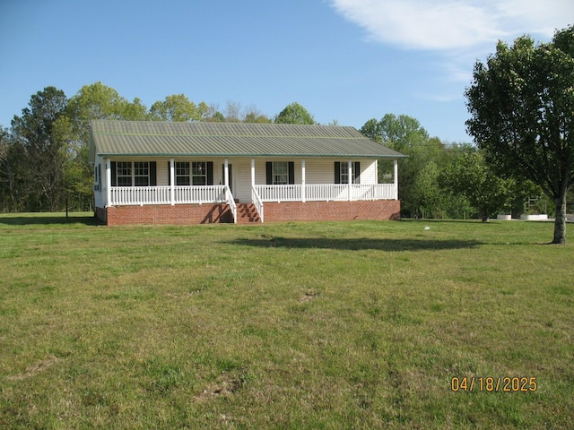 view of front of property with metal roof, a front lawn, and covered porch