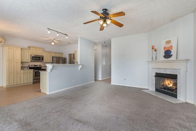 1007 Whitley Pl, Hendersonville, TN 37075 - unfurnished living room featuring ceiling fan, a textured ceiling, light carpet, a high end fireplace, and baseboards