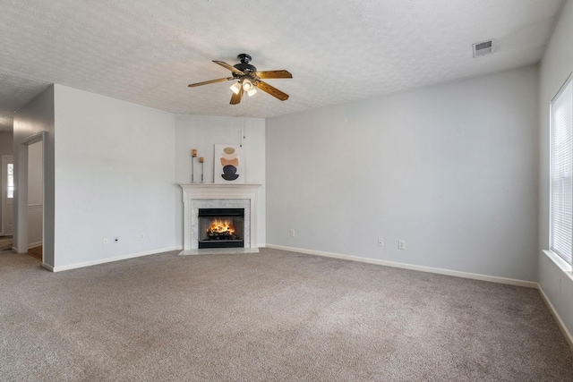 1007 Whitley Pl, Hendersonville, TN 37075 - unfurnished living room with a textured ceiling, a ceiling fan, visible vents, carpet floors, and a high end fireplace
