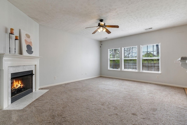 1007 Whitley Pl, Hendersonville, TN 37075 - unfurnished living room with a textured ceiling, a ceiling fan, visible vents, a high end fireplace, and carpet