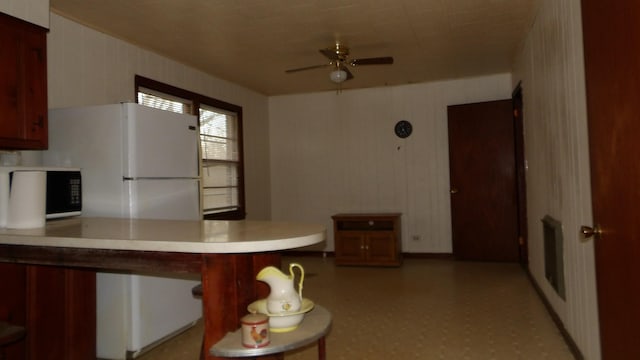 kitchen with light countertops, a ceiling fan, and light floors