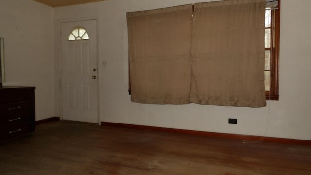 entryway featuring baseboards and wood finished floors