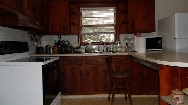 kitchen featuring a sink, light countertops, open shelves, and electric range oven