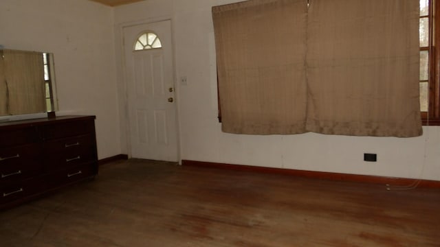 foyer entrance with wood finished floors and baseboards