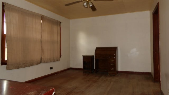 interior space featuring wood finished floors, ceiling fan, and baseboards