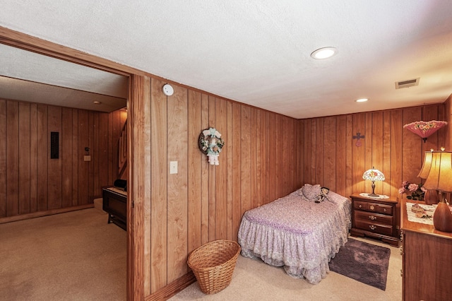 170 N Leath Rd, Portland, TN 37148 - carpeted bedroom featuring wooden walls, visible vents, and a textured ceiling