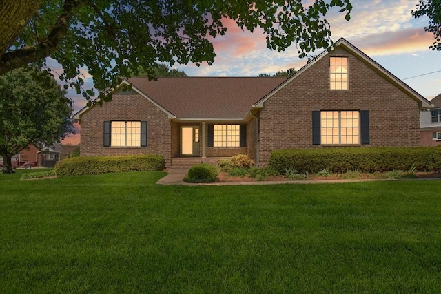 view of front of property with brick siding and a front yard