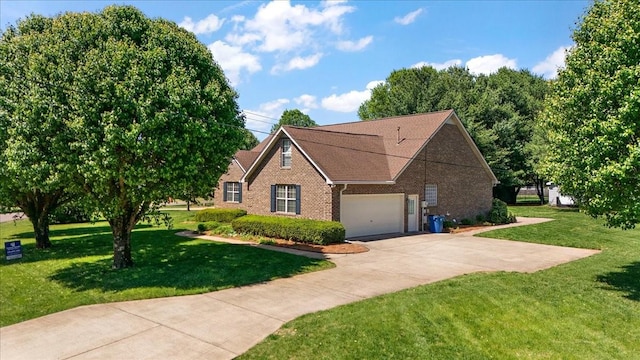 view of front of property with an attached garage, driveway, brick siding, and a front yard