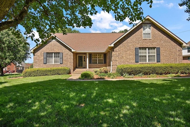 ranch-style house featuring brick siding and a front yard