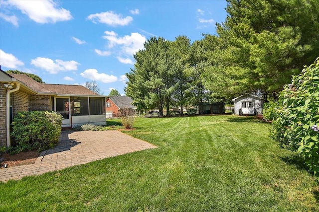 view of yard with a sunroom and a patio