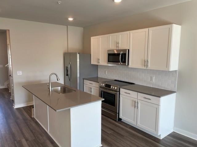 341 Casper Dr, Spring Hill, TN 37174 - kitchen featuring dark wood-type flooring, tasteful backsplash, a sink, and stainless steel appliances