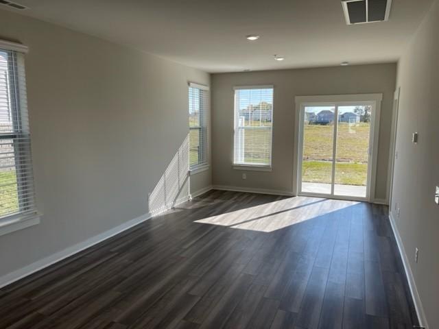 341 Casper Dr, Spring Hill, TN 37174 - spare room featuring visible vents, dark wood-style flooring, and baseboards
