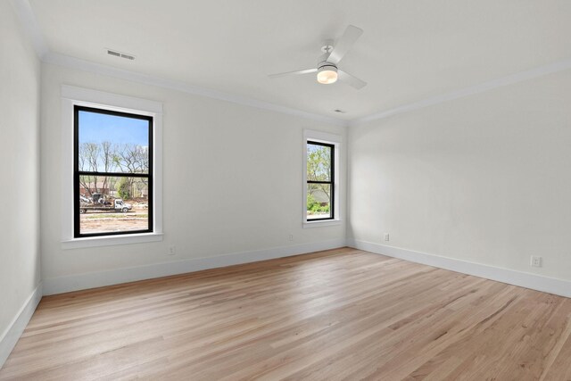 unfurnished room featuring ornamental molding, light wood-style flooring, and baseboards