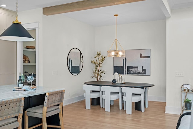 dining room with recessed lighting, a notable chandelier, baseboards, and light wood-style flooring