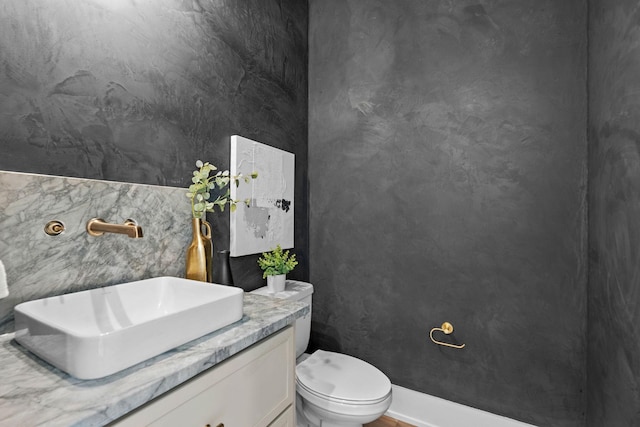 bathroom featuring toilet and vanity
