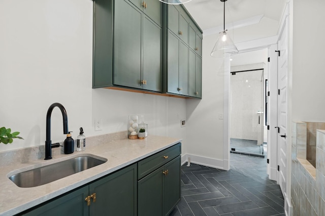 kitchen with decorative light fixtures, green cabinets, and a sink