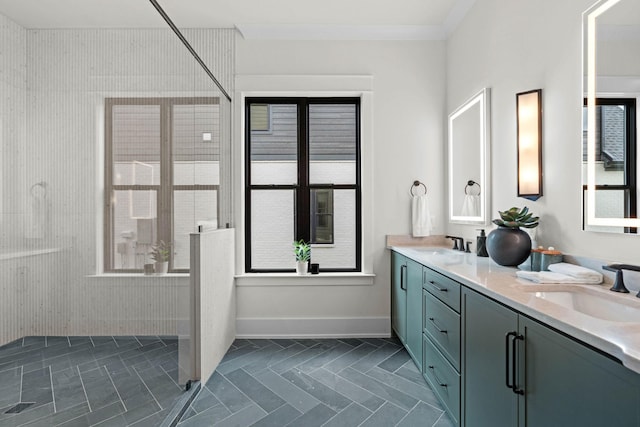 bathroom with a sink, a shower stall, double vanity, and a healthy amount of sunlight