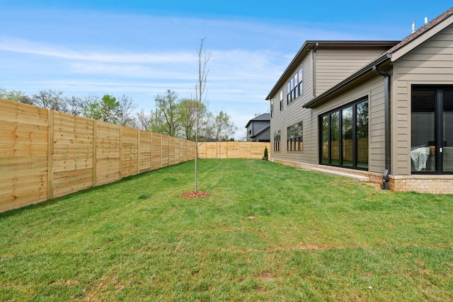 view of yard with a fenced backyard