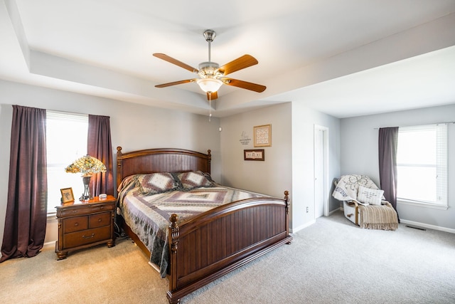 2403 English Hill Dr, Murfreesboro, TN 37130 - bedroom featuring visible vents, baseboards, a raised ceiling, ceiling fan, and light carpet