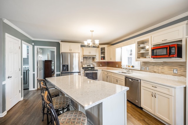2403 English Hill Dr, Murfreesboro, TN 37130 - kitchen with a center island, a notable chandelier, dark wood finished floors, crown molding, and stainless steel appliances