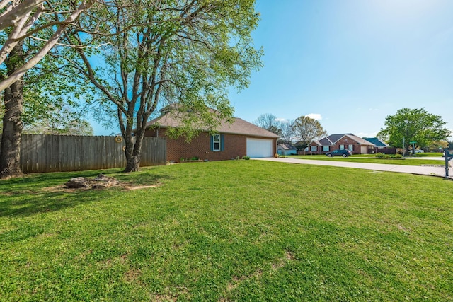 2403 English Hill Dr, Murfreesboro, TN 37130 - view of yard with an attached garage, fence, and concrete driveway