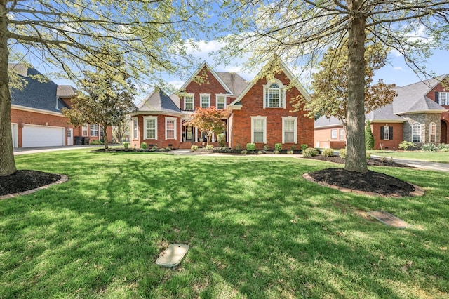 traditional-style home featuring brick siding and a front lawn
