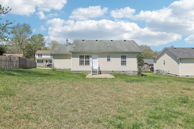 back of house with a yard, entry steps, and fence