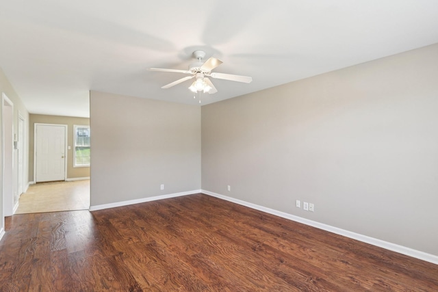 empty room featuring baseboards, a ceiling fan, and wood finished floors