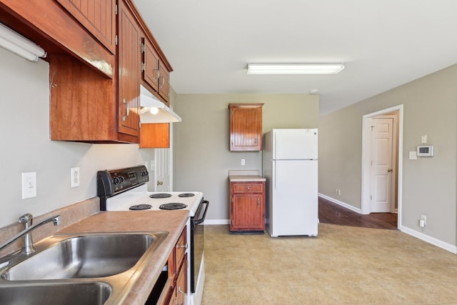 kitchen featuring freestanding refrigerator, under cabinet range hood, a sink, electric stove, and brown cabinets