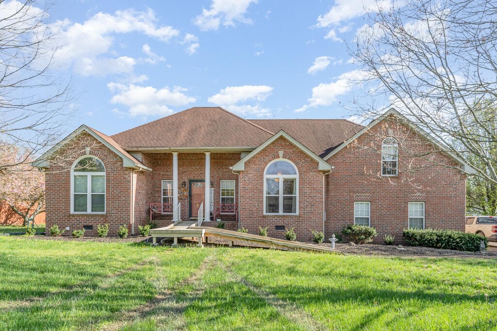 106 Willow Crest Ct, Goodlettsville, TN 37072 - view of front of house featuring brick siding, a front yard, a shingled roof, and crawl space