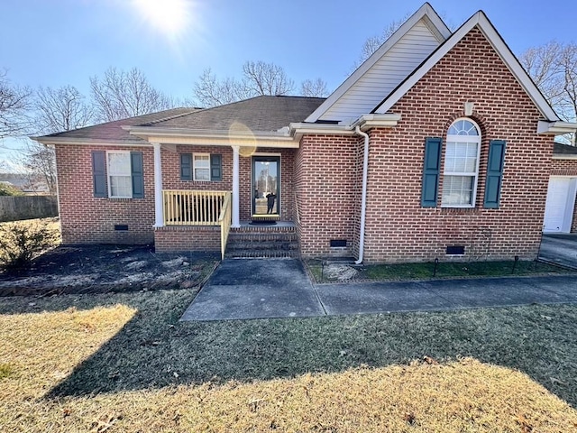 view of front of home featuring crawl space, a shingled roof, brick siding, and a porch