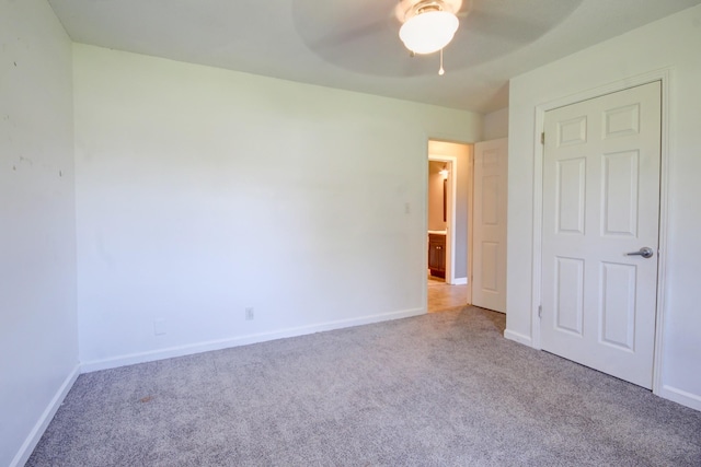 unfurnished bedroom with baseboards, a ceiling fan, and carpet