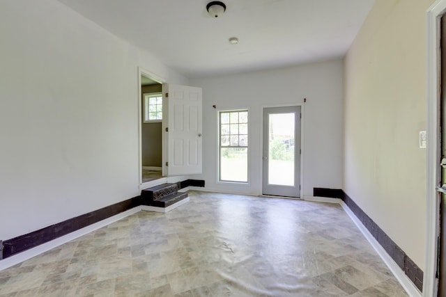 doorway to outside with baseboards
