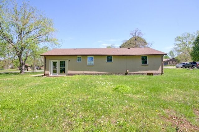 back of house with a yard