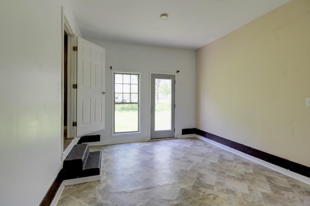entryway featuring baseboards
