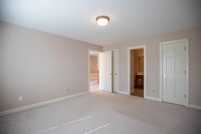 2132 Neelys Bend Rd, Madison, TN 37115 - unfurnished bedroom featuring light colored carpet, baseboards, and ensuite bath