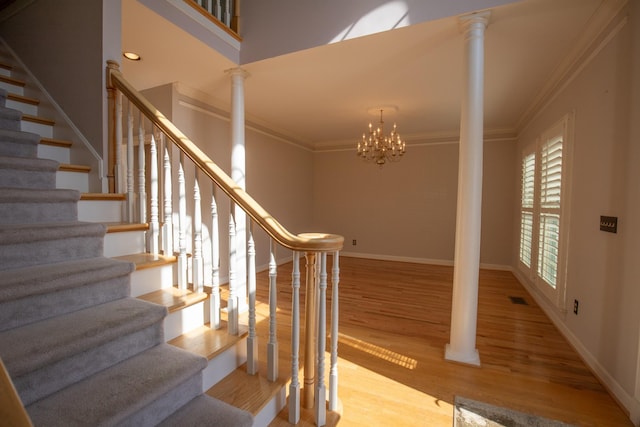 2132 Neelys Bend Rd, Madison, TN 37115 - staircase featuring crown molding, decorative columns, wood finished floors, a chandelier, and baseboards