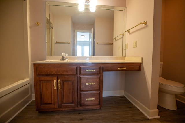 2132 Neelys Bend Rd, Madison, TN 37115 - bathroom with toilet, vanity, wood finished floors, and baseboards