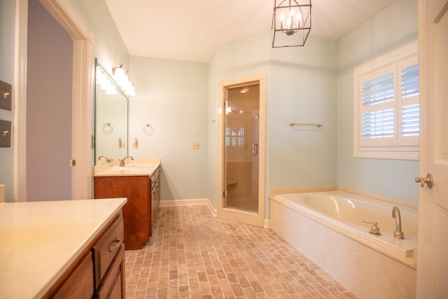 2132 Neelys Bend Rd, Madison, TN 37115 - full bathroom featuring vanity, a shower stall, a garden tub, a chandelier, and brick patterned floors